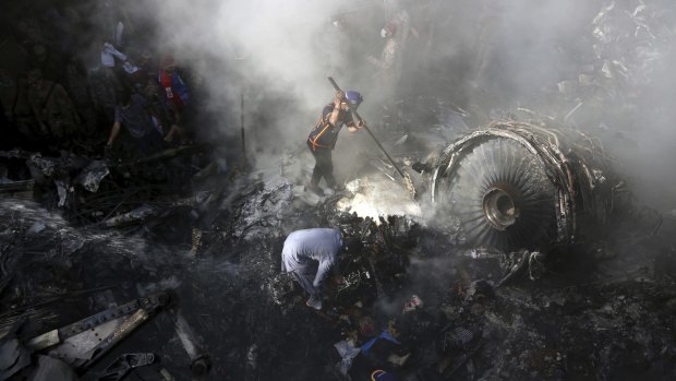 Wreckage is searched after the crash of a Pakistan International Airlines flight in May. 