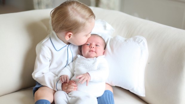 Prince George kisses his baby sister Princess Charlotte.