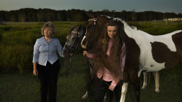 Kim-Leanne King, with her youngest daughter Madeline and their Appaloosa horses, worries she exposed her children to poison in the Williamtown area.