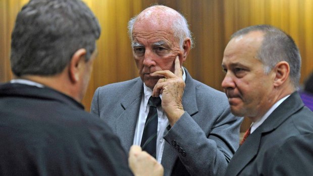 Former grand slam doubles tennis champion Bob Hewitt (centre) looks on during his sentencing at a high court in Pretoria.