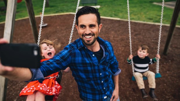 Lachlan Searle with his children Tom, 4, and Lottie, 3, at their local park in Deakin.