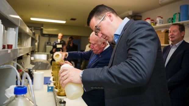 ACT Senator Zed Seselja and ACT Minister for the Environment and Heritage Mick Gentleman test water samples at the University of Canberra.