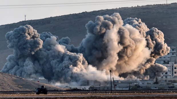 Smoke rises during air strikes on Kobane seen from the Turkish-Syrian border.