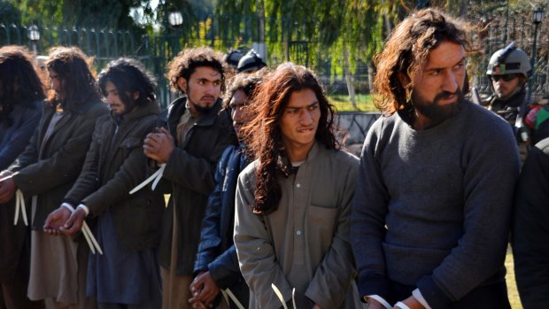 Taliban fighters are handcuffed by Afghan security forces, in Jalalabad, capital of Nangarhar province, on Tuesday.