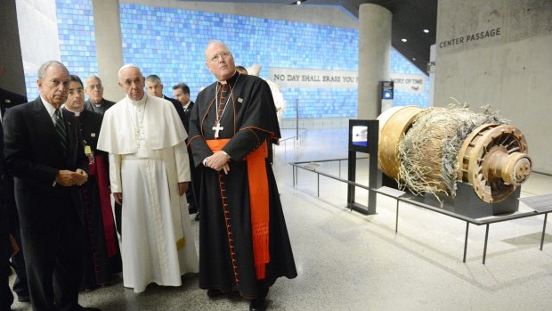 Former New York Mayor Michael Bloomberg, left, Pope Francis, and Cardinal Timothy Dolan, right, look at a segment of the radio and television antenna that was damaged in the attacks of September 11, 2001.