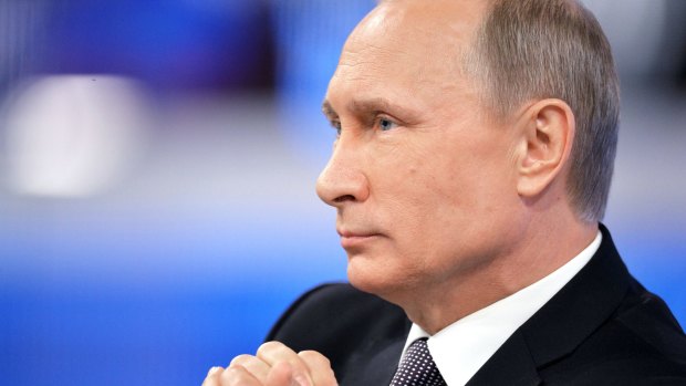 Russian President Vladimir Putin listens during an annual call-in show on Russian television in Moscow on Thursday.