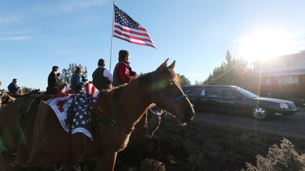 A riderless horse is used to honor LaVoy Finicum as his hearse drives by during the funeral in Kanab, Utah, last week.