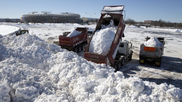 Snow from around the Washington area is dumped in the parking lot of Robert F. Kennedy Memorial Stadium in Washington.