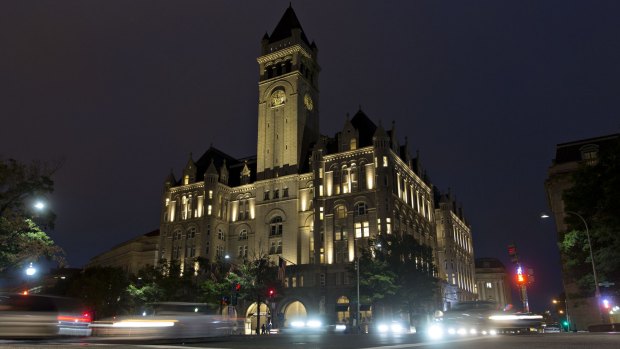 Vehicles pass the Trump International Hotel, formerly the Old Post Office Pavilion, in Washington.