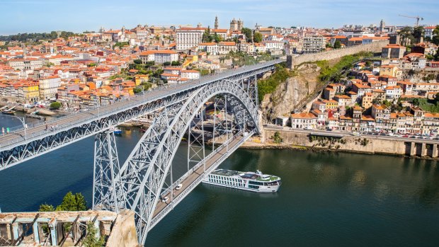 Emerald Radiance cruises a river in Porto.