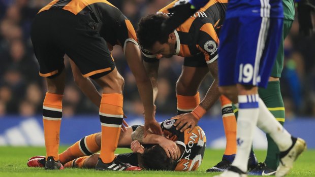 Ryan Mason of Hull City lies injured after the collision.