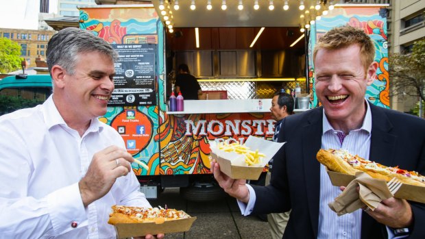 Justin Parry-Okeden and Ian Hudspith lunch on pulled pork rolls from the Monster Roll truck in Queen's Square.