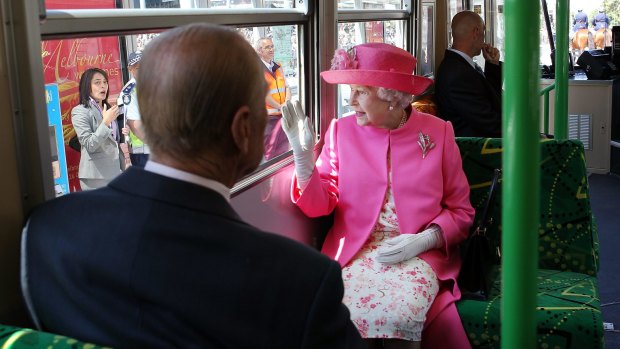 The Queen rides a tram through Melbourne. 