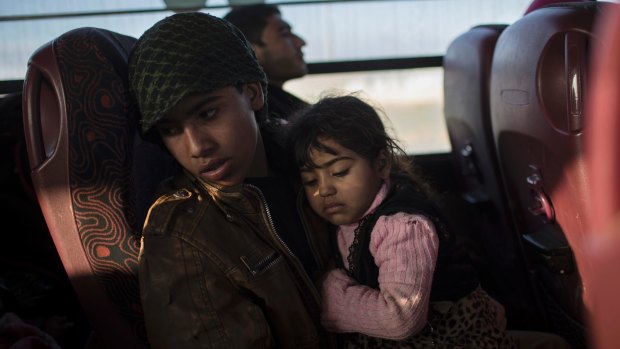 Displaced Iraqis, fleeing fighting between Iraqi security forces and Islamic State militants, ride on a bus to the Hassan Sham camp, east of Mosul, last week.