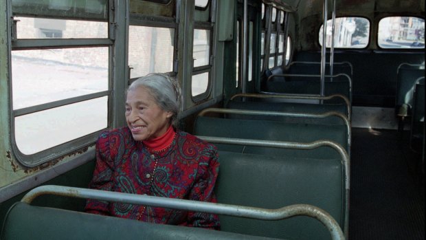 Civil rights pioneer Rosa Parks sits in a 1950s-era bus in Alabama, in this 1995 file photo, 40 years after she was arrested for refusing to give up her seat on a city bus to a white person. 