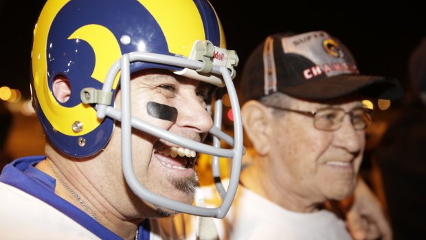 Football fans Duane Vallejos, left, and his father, Bert, a Rams fan since 1953, from Walnut, California celebrate the return of their team to Los Angeles.
