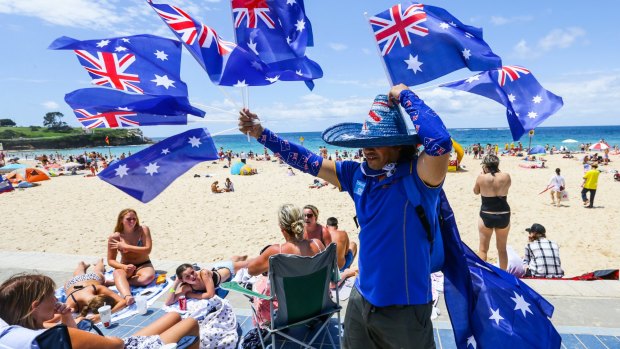 Flag seller on Coogee Beach as the crowds enjoy the sunshine on Australia Day in 2016.