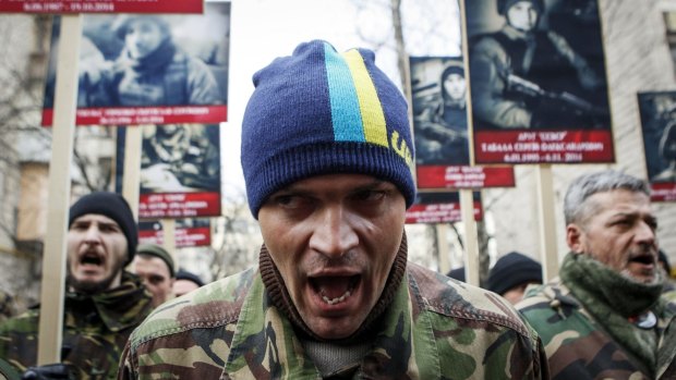 Activists of the Right Sector political party hold posters displaying Ukrainian troops that have been killed during the conflict as they attend an anti-government march in Kiev.