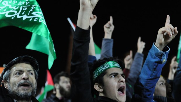 Protesters in Istanbul holding Islamic and Palestinian flags, chant anti-US slogans during a rally on Saturday.