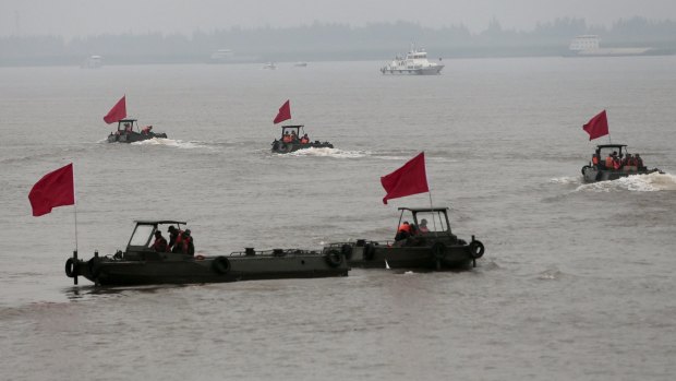 Paramilitary soldiers ride boats near the site of a sunken ship in the Jianli section of Yangtze River.