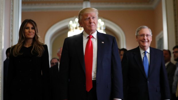 President-elect Donald Trump and his wife Melania walk with Senate Majority Leader Mitch McConnell on Capitol Hill on Thursday.