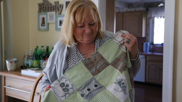 Teri Kroll holds her 'Timmy Blanket', made from scraps of her dead son's clothes.