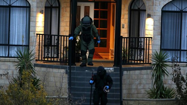Officers leaving a Greenvale property during counter-terrorism operation.