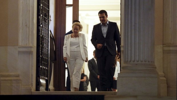 Greece's caretaker prime minister Vassiliki Thanou (left) escorts outgoing prime minister Alexis Tsipras following a handover ceremony at the prime minister's office at Maximos Mansion in Athens on Thursday. 