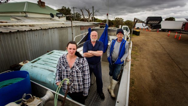 Phil McAdam (centre), his daughter Kat, and Carl Spicer at the Maddox Road boathouses in Williamstown North. The state government announced all commercial net fishing will cease by 2022.
