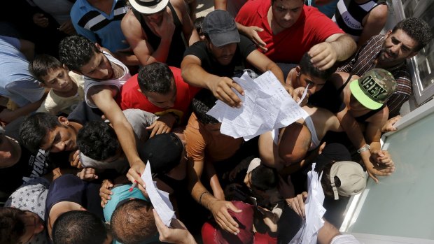 Syrian refugees push to get registered on the Greek island of Kos.
