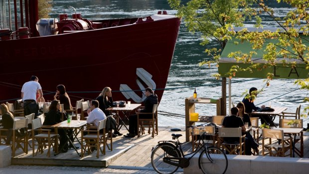 Riverside view: Lyon, a Cafe Terrace on the quai Victor Augagneur on the Rhone River.