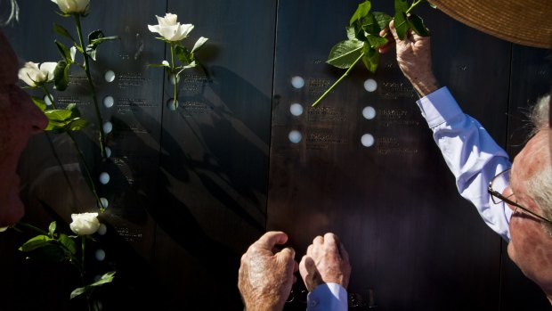 BRISBANE, AUSTRALIA - OCTOBER 17:  Retired miners placing flowers into the memorial holes in memory of their fallen comrades. A memorial to Coal Miners who have died is unveiled on October 17, 2015 in Brisbane, Australia.  (Photo by Robert Shakespeare/Fairfax Media)
