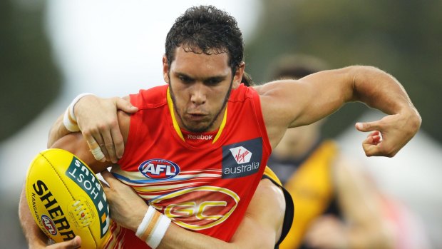 Being pursued: Harley Bennell of the Gold Coast Suns.