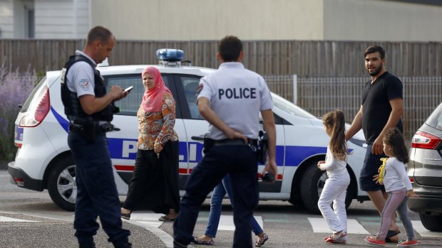 Police officers investigate an attack on a church that left a priest dead in Saint-Etienne-du-Rouvray.