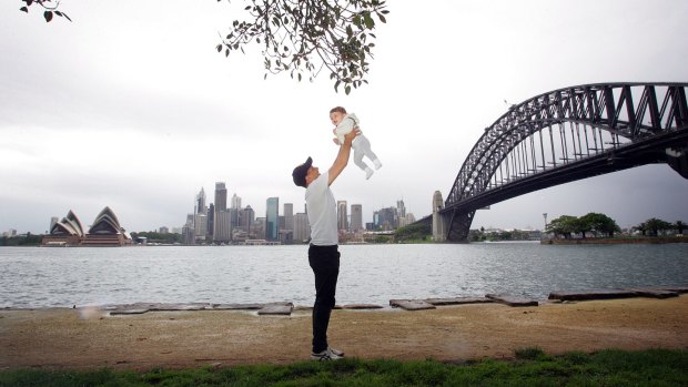 Sensitive city: Peter Tsigolis and his one-year-old son Orlando take in the Sydney Harbour experience from the shore.