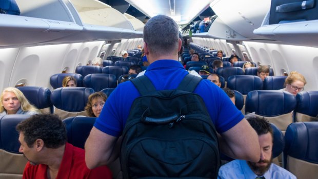 Be aware of backpacks and shoulder bags when walking down airplane