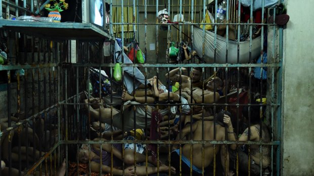 Prisoners inside a cell in Manila Police Headquarters, Philippines, most arrested  under tough drug laws.
