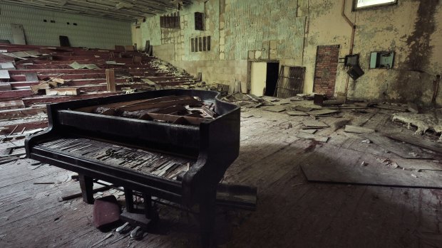 Ruined grand piano in a concert hall in Pripyat in the Chernobyl Exclusion Zone.