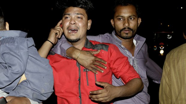 A man at the scene of Sunday's bomb blast in Lahore waits for news of relatives.