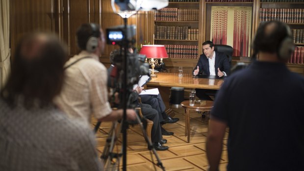 Greece's Prime Minister Alexis Tsipras interviewed by a television journalist on Tuesday.