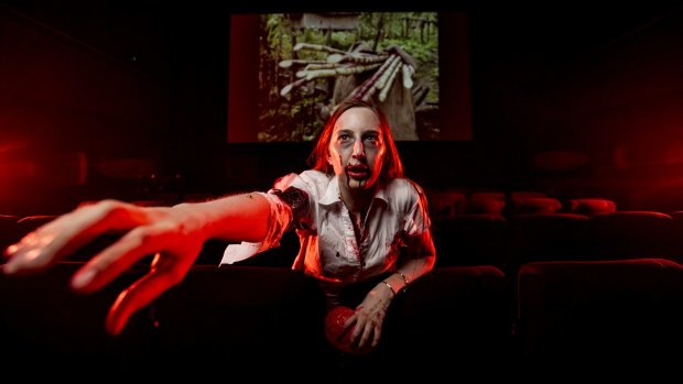 Jae Burns, of the Canberra Zombie Walk, getting in character to spend the scariest night of the year in one of Australia's most haunted buildings, the former Institute of Anatomy, for an all-night movie marathon at the Arc cinema. 