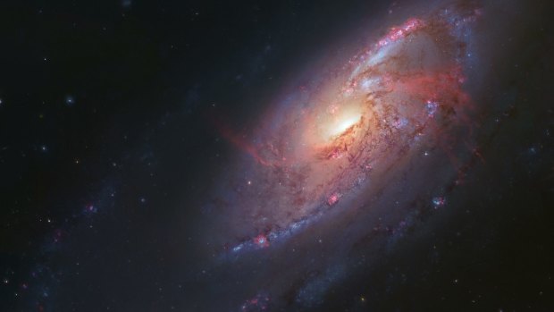 The Messier 106 or NGC 4258 galaxy, 23.5 million light years away from Earth. Measuring stars called "masers" in this galaxy helped calculate the local Hubble constant.