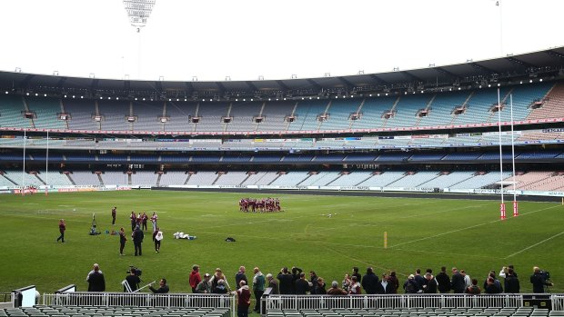 The Maroons huddle together during a training session at the MCG on Tuesday.