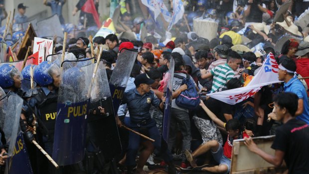 Police fire water cannons at student activists as they clash near the venue hosting the APEC summit in Manila.