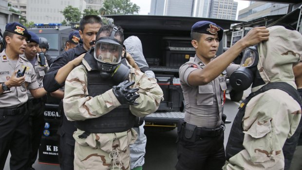 Members of the police bomb squad put on their protective gear prior to examining the site of an explosion in Jakarta in January. 
