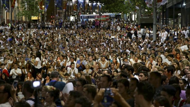A massive crowd converges to pay tribute to the Paris victims in Martin Place.