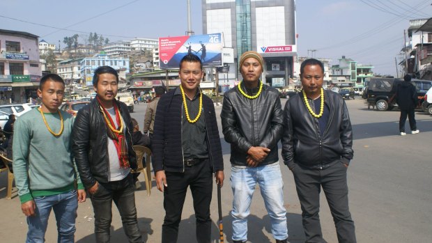 Naga men wearing yellow necklaces, a symbol of the Angami tribe, wait to block government vehicles in the streets of Kohima.