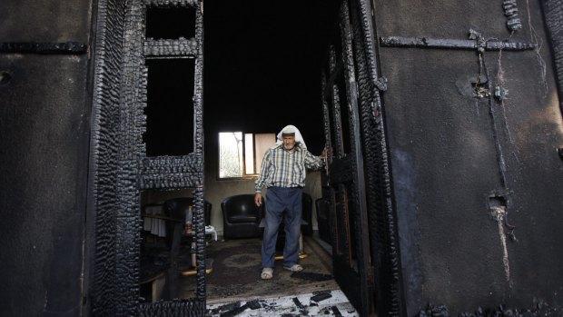 A Palestinian inspects a house last year after it was torched in a suspected attack by Jewish settlers, killing an 18-month-old Palestinian child and his parents, at Duma village near the West Bank city of Nablus.