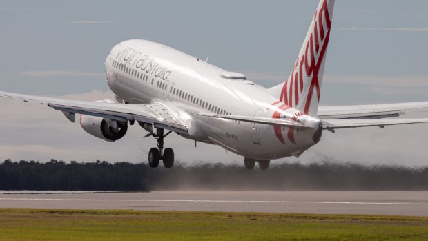 The first flight from Brisbane Airport's new runway - Virgin Australia flight VA781 to Cairns - takes off on Sunday.