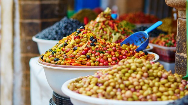 Selection of pickled olives on a traditional Moroccan market (souk) in Essaouira, Morocco.